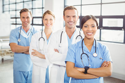 Four Medical Professionals smiling (two females and two males)
